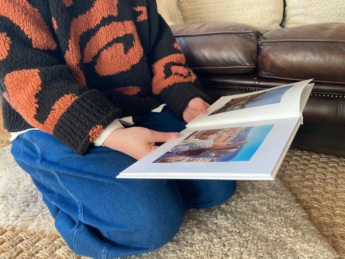 Looking at a travel photo book from There & Back Editions